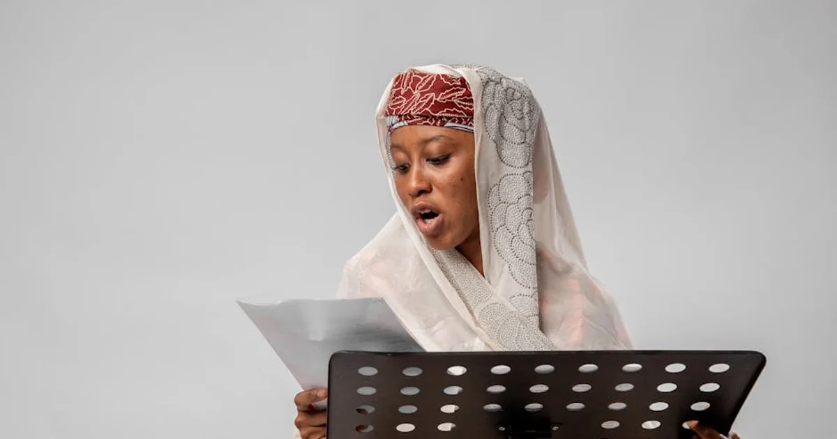 A professional Nigerian voice actor with headphones recording into a microphone in a modern studio, representing cultural authenticity in voiceover for a global audience.