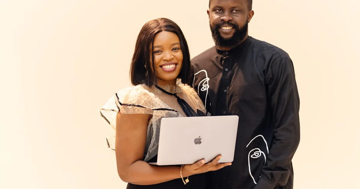 A professional Nigerian English voice actor, a man in a modern recording studio, speaking into a microphone for a corporate video voice over, with a screen displaying business graphics in the background, symbolizing global reach and authenticity.