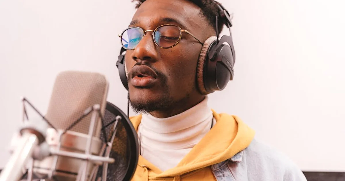 Nigerian voice actor in a recording studio with a professional microphone