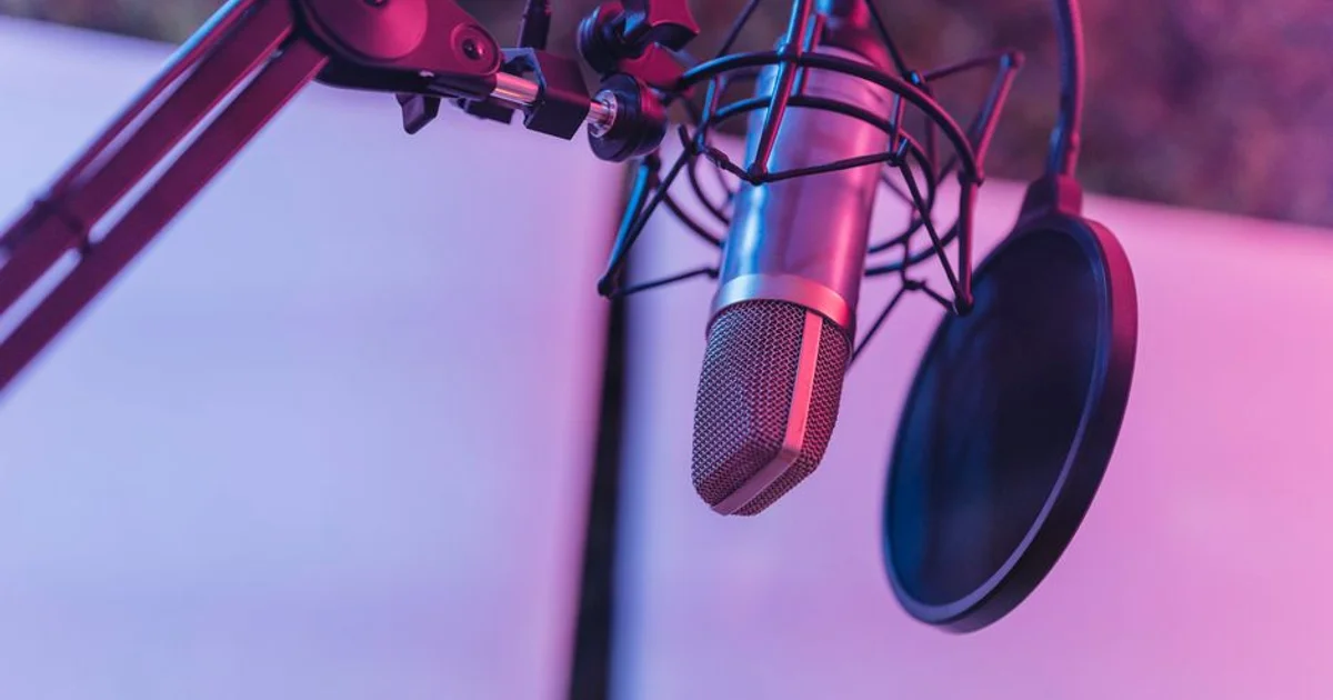 Professional Nigerian voice actor recording high‑quality audio in a sound‑treated studio for YouTube narration