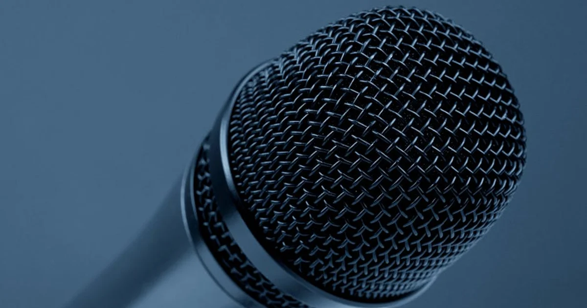 A professional Nigerian female voice actor in a sound booth, wearing headphones and speaking into a microphone, recording an IVR system with a script on a stand. The scene emphasizes cultural authenticity and modern voice-over technology.