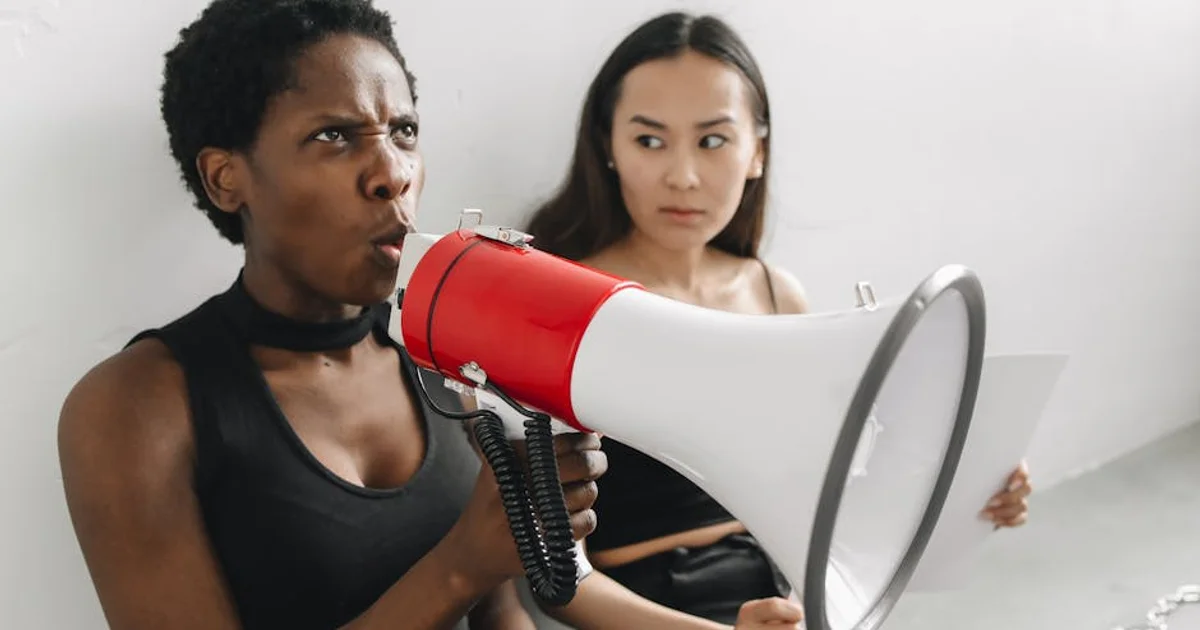 A professional Nigerian voice actor in a recording studio, wearing headphones and speaking into a microphone, with a warm, engaging expression, symbolizing cultural authenticity in voiceover.